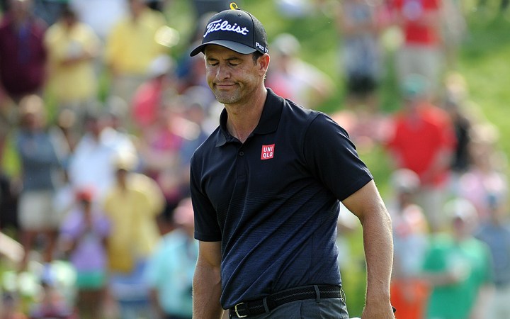 Adam Scott shows his disbelief after missing a birdie putt on 18.