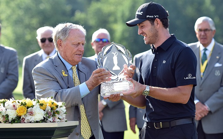 Jack Nicklaus gives Patrick Cantlay the Memorial trophy.